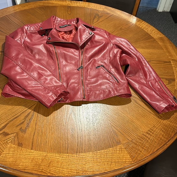 New perfect condition red faux leather jacket. Adorned with zippers and snaps. - Picture 2 of 8